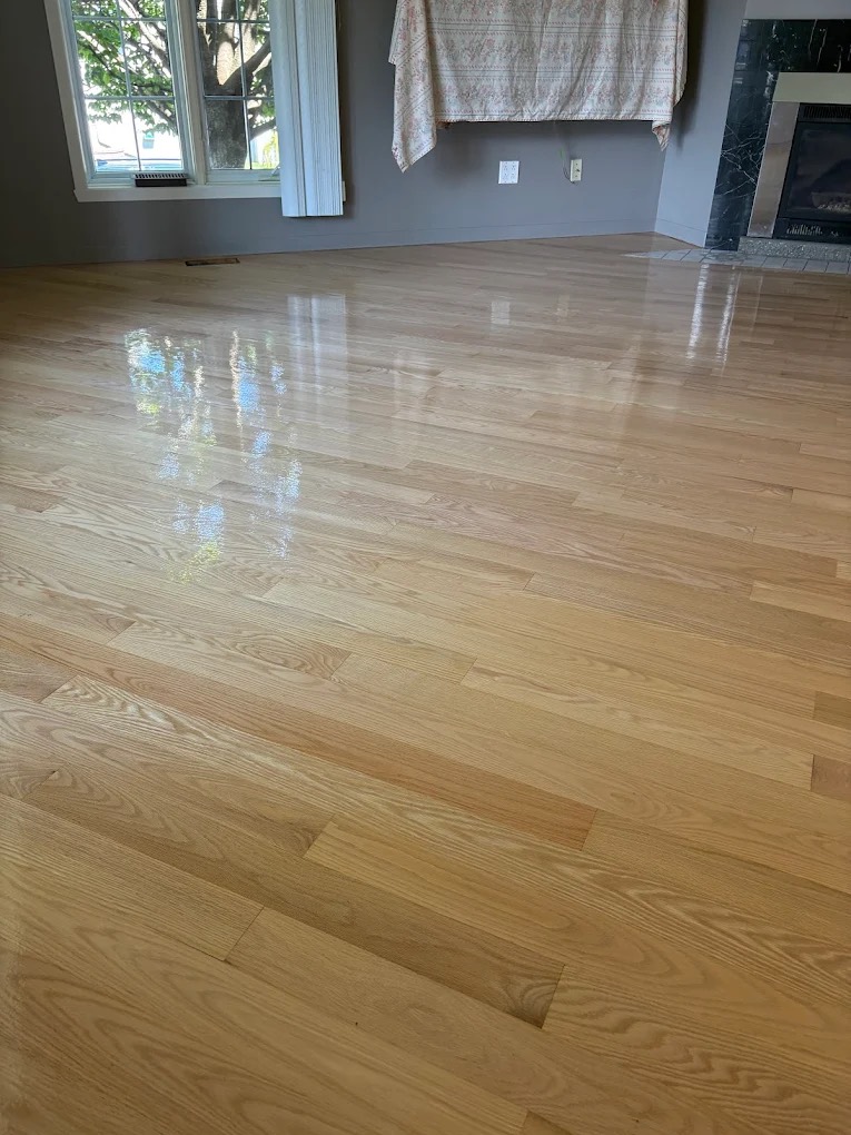 A glossy, freshly refinished oak floor by Planchers Locas