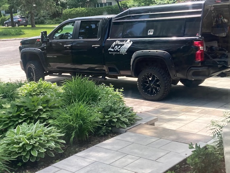 The branded Planchers Locas company truck outside a recent project