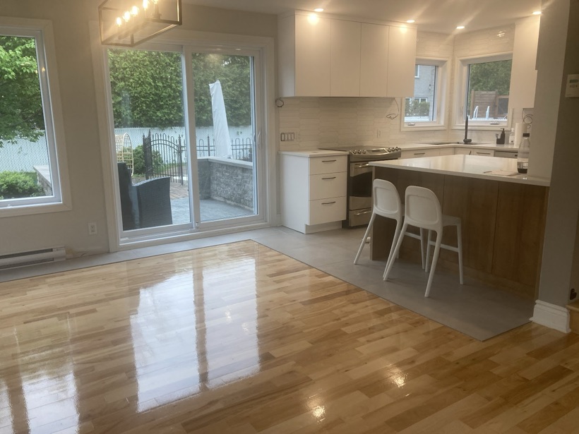 A hardwood floor being repaired and board-matched by Planchers Locas